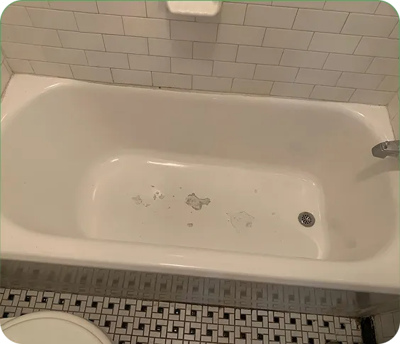 Before repair view of a bathtub with visible rust and enamel damage